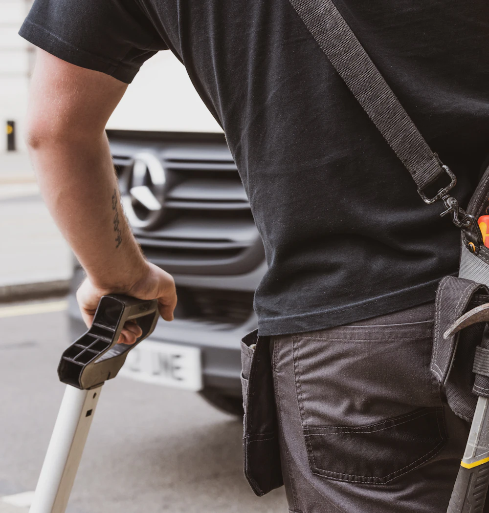 A handyman with a tool belt full of tools